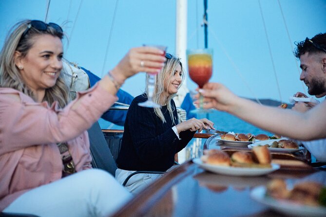 Athens Sunset Dinner Cruise – Swim Stop, Dinner & Open Bar - Dinner on a wooden boat near the island