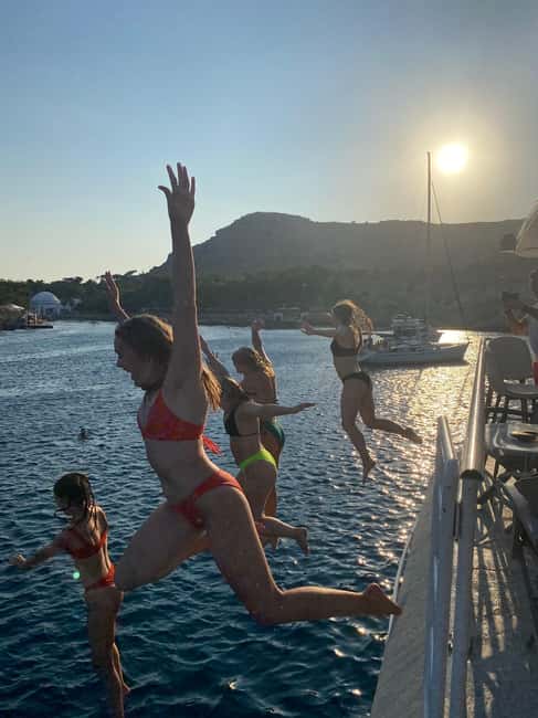 Rhodes: Sunset Cruise with Open Bar, Dinner, & Live Music - Leaving Mandraki Port with Rhodes behind you