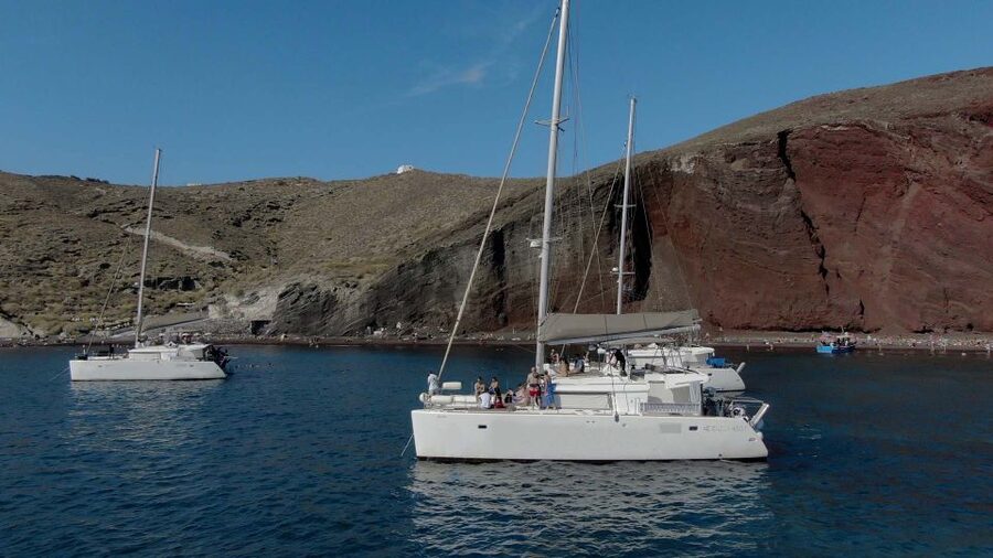 Santorini: Sunset Cruise with Greek Dinner and Transfer - Red Beach and White Beach by boat