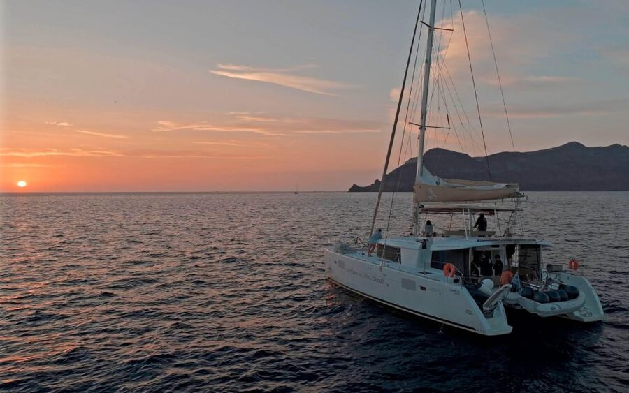 Santorini: Sunset Sailing Cruise, with Dinner and Drinks - White Beach, Indian Rocks, and the Akrotiri Lighthouse